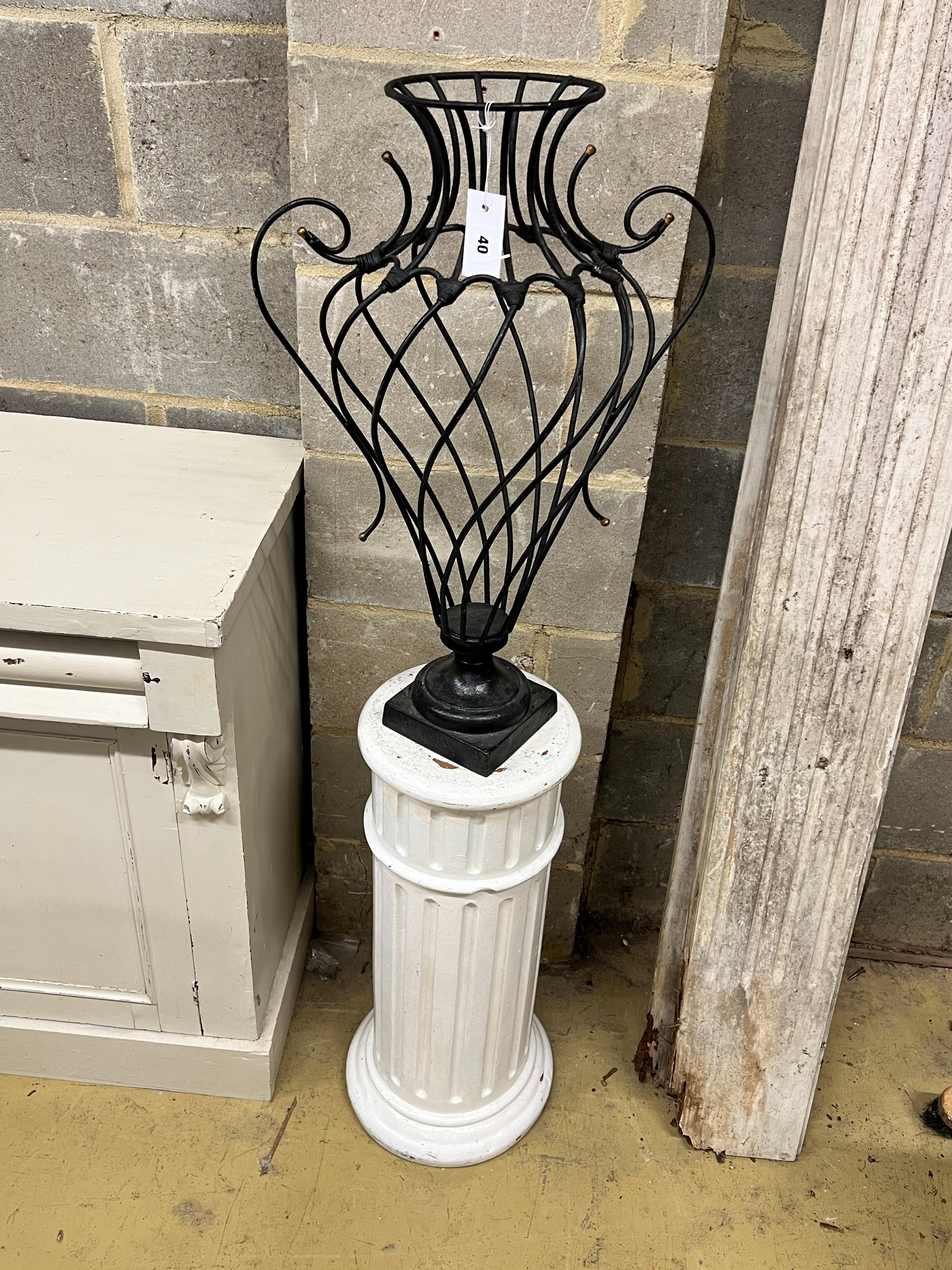 A painted wrought iron vase shaped ornament on painted fluted pedestal, total height 139cm